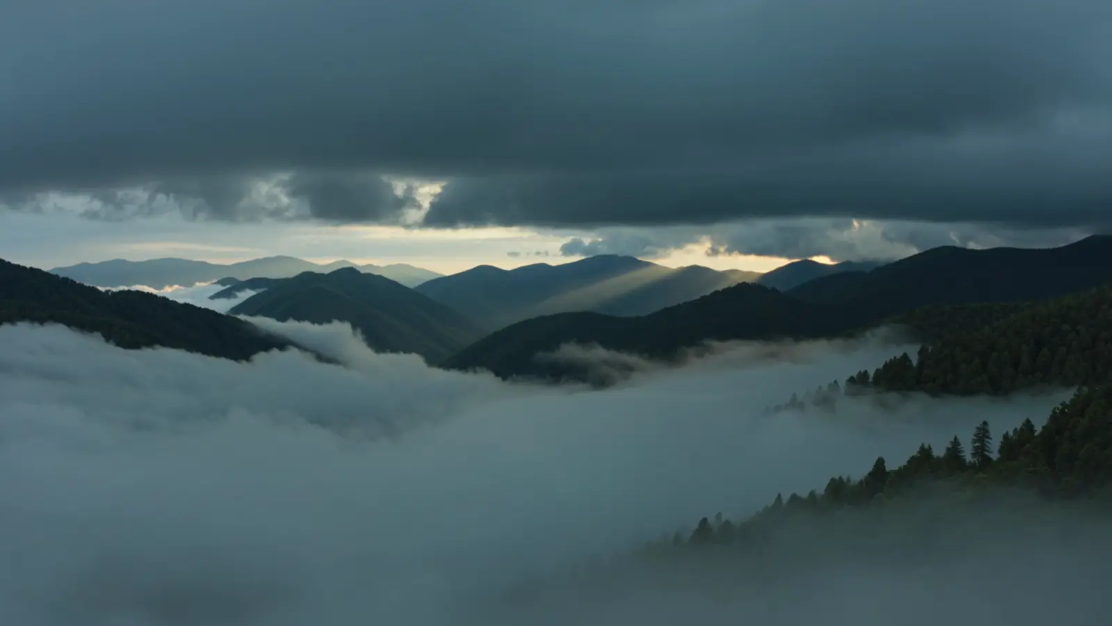 Layers of the Blue Ridge Mountains beneath a dramatic sky