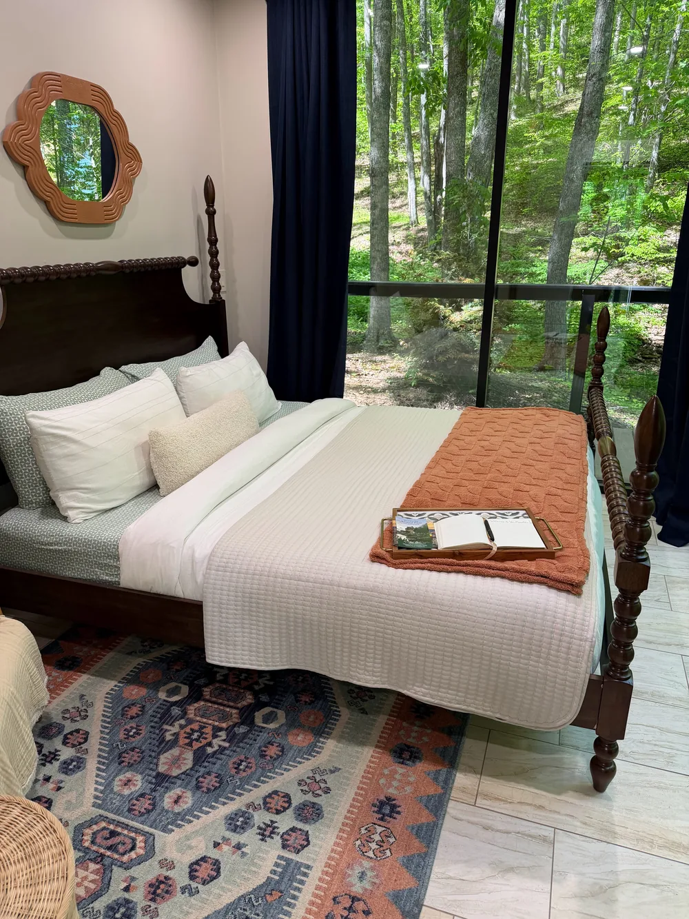 A freshly made guest bedroom in a mountain home, cleaned by Golden Bee